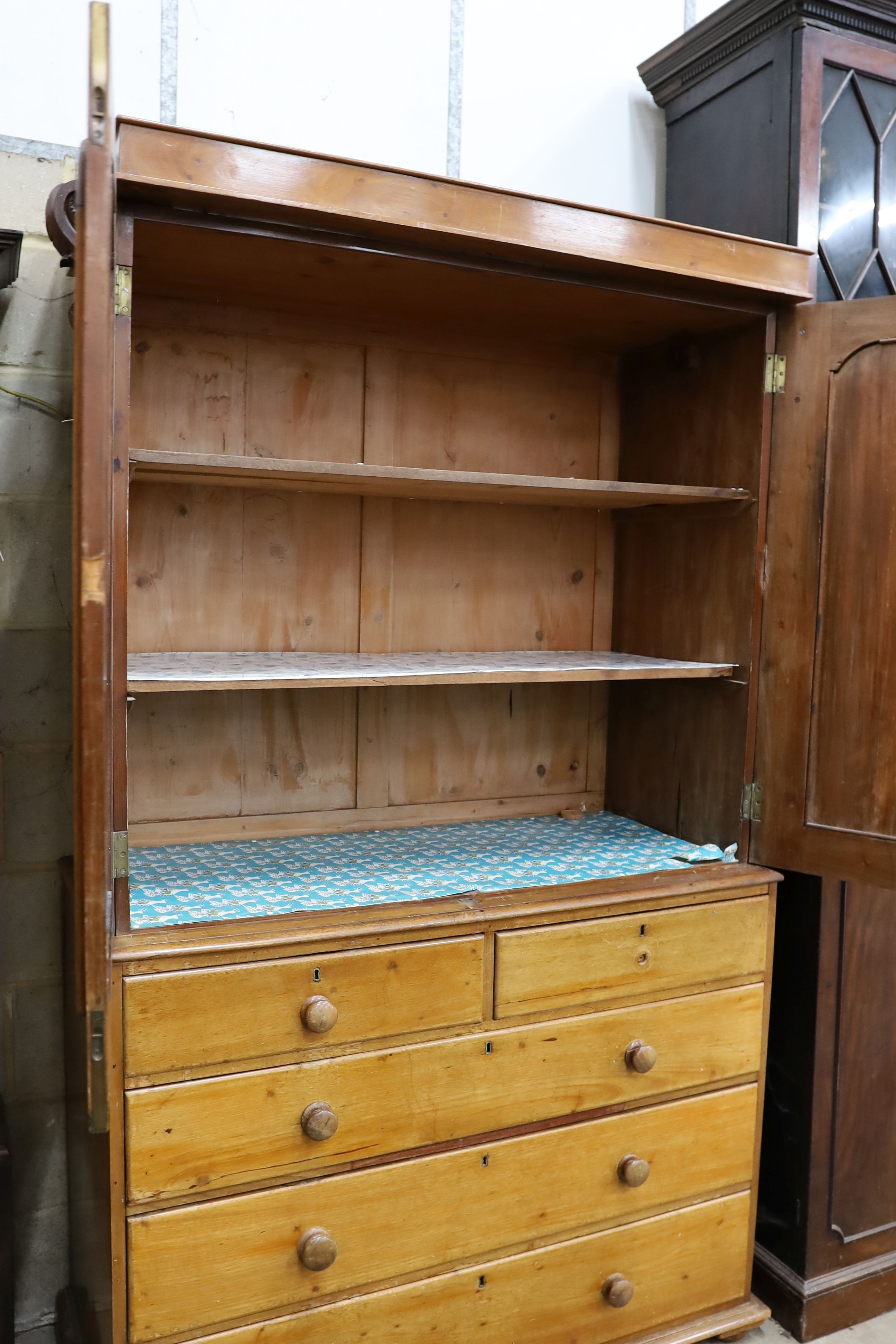 A Victorian satin walnut press cupboard, fitted a pair of doors over two drawers and three long drawers on plinth base, width 124cm, depth 56cm, height 210cm